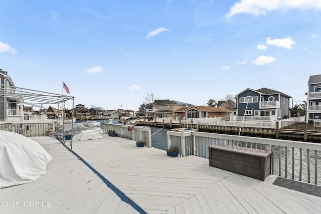 wooden terrace featuring a water view and a residential view