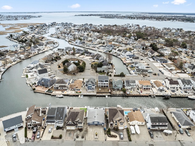 birds eye view of property with a water view and a residential view