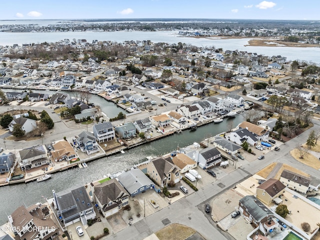 drone / aerial view featuring a residential view and a water view