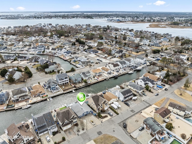 drone / aerial view featuring a water view and a residential view