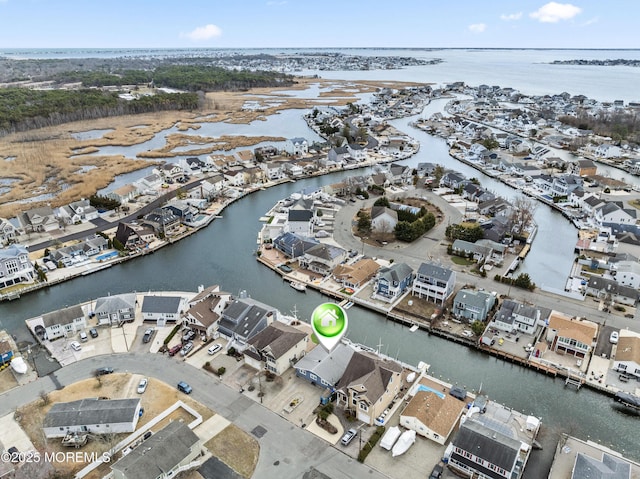 drone / aerial view with a residential view and a water view