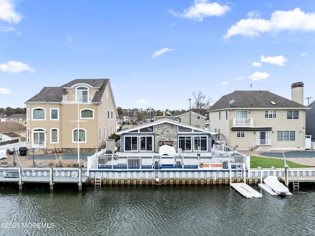 back of house with a deck with water view