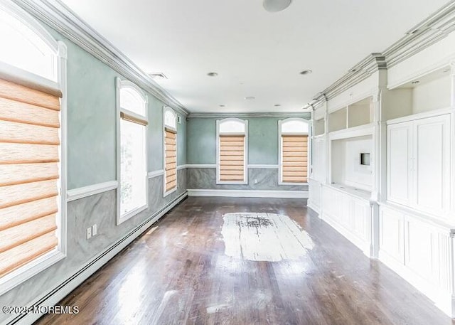 empty room with a baseboard radiator, dark wood-style flooring, wainscoting, and crown molding