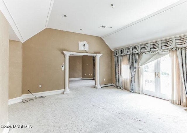 empty room with visible vents, baseboards, a baseboard radiator, vaulted ceiling, and french doors