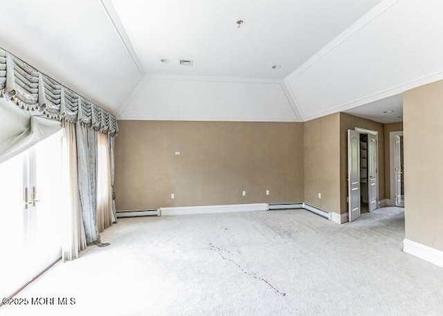 empty room featuring baseboard heating, baseboards, and vaulted ceiling