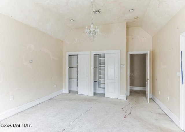 unfurnished bedroom featuring lofted ceiling, baseboards, and two closets