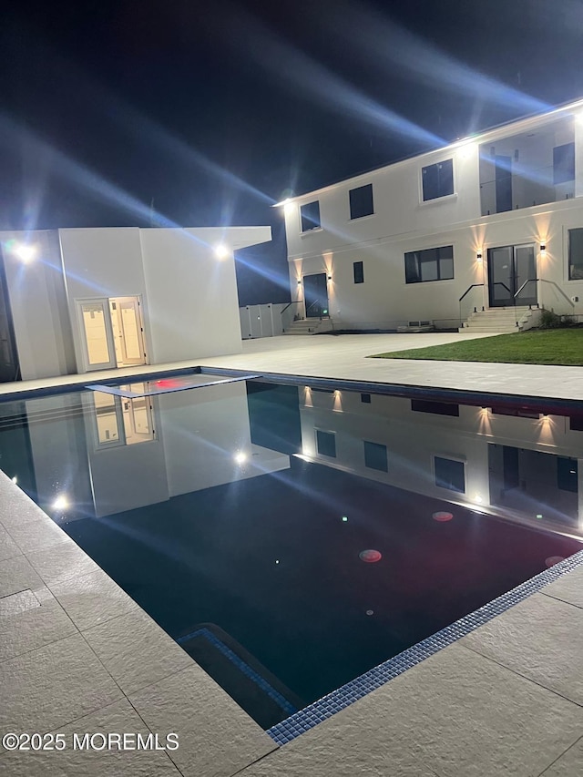 view of swimming pool featuring entry steps and a patio