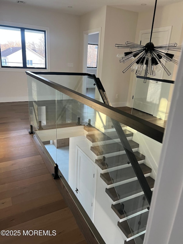 stairs featuring wood finished floors and baseboards