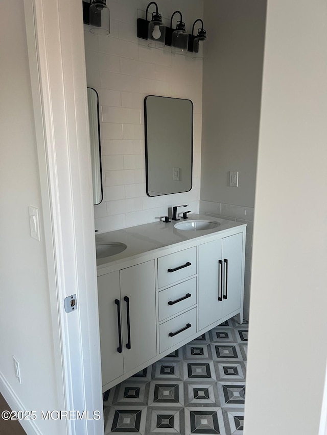 bathroom featuring double vanity, a sink, and tile patterned floors