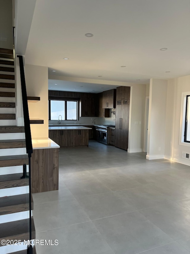 kitchen featuring baseboards, modern cabinets, visible vents, and premium appliances