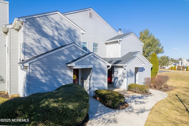 view of front facade with a front yard and a chimney