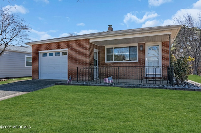 view of front of home featuring a garage, brick siding, driveway, and a front lawn