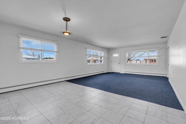 carpeted spare room with a baseboard radiator, visible vents, and baseboards