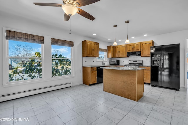 kitchen featuring a kitchen island, range hood, baseboard heating, brown cabinets, and black appliances