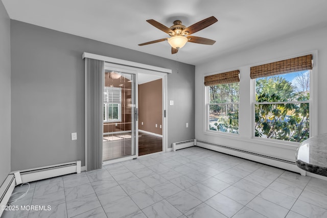 empty room featuring a ceiling fan, marble finish floor, baseboards, and baseboard heating