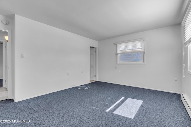 unfurnished room featuring a baseboard radiator, baseboards, and carpet