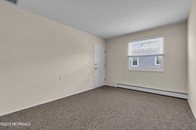 spare room with a baseboard radiator, baseboards, and carpet