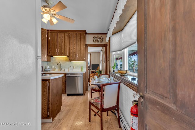 2-4 NE Central Ave, Seaside Park, NJ 08752 - kitchen with light wood-type flooring, freestanding refrigerator, brown cabinetry, light countertops, and dishwasher