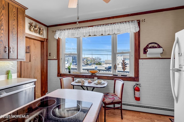 2-4 NE Central Ave, Seaside Park, NJ 08752 - dining space featuring a baseboard radiator, light wood-style floors, ornamental molding, and a ceiling fan