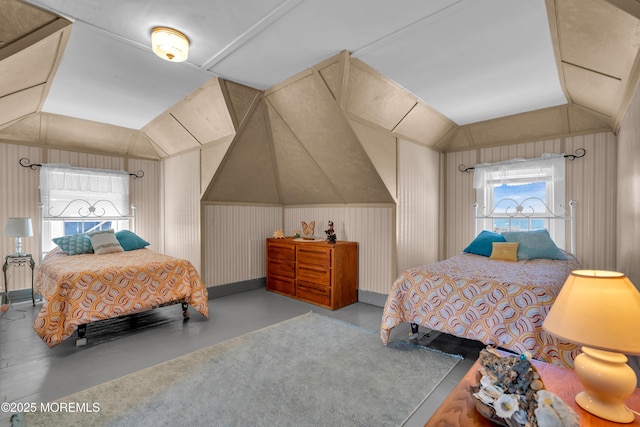 2-4 NE Central Ave, Seaside Park, NJ 08752 - bedroom featuring multiple windows, finished concrete flooring, and lofted ceiling