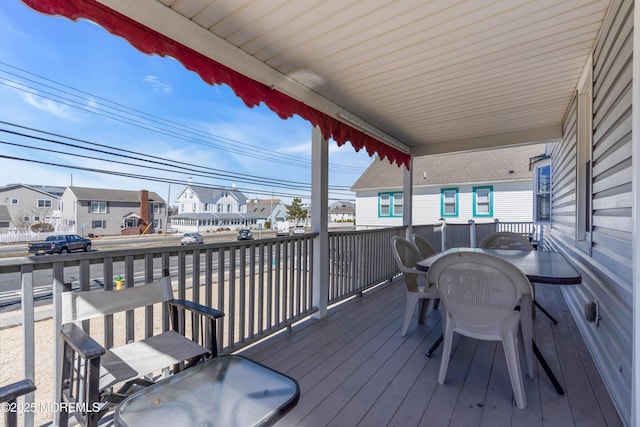 2-4 NE Central Ave, Seaside Park, NJ 08752 - wooden deck with outdoor dining space and a residential view