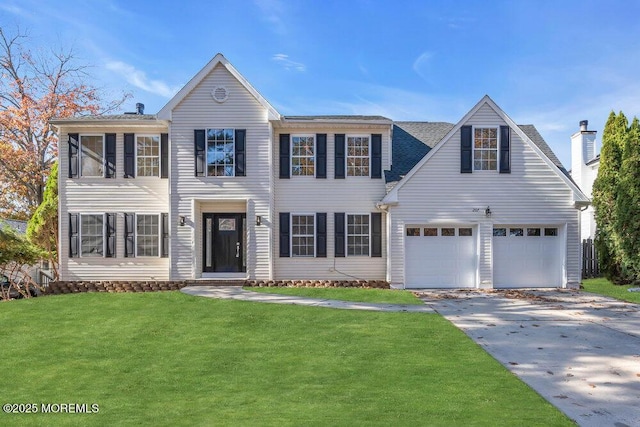 colonial inspired home featuring an attached garage, driveway, and a front lawn