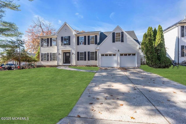 view of front of home featuring a garage, a front yard, and driveway