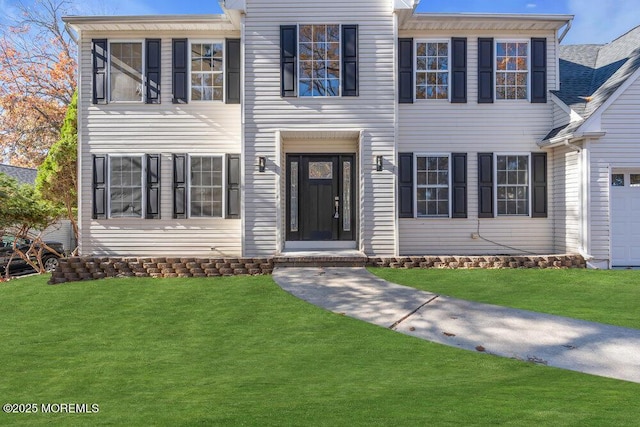 view of front of property with driveway and a front yard