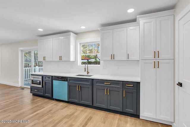 bar with dishwasher, light wood-style floors, a wealth of natural light, and a sink