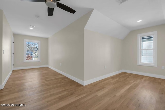 bonus room with light wood-style floors, plenty of natural light, and baseboards