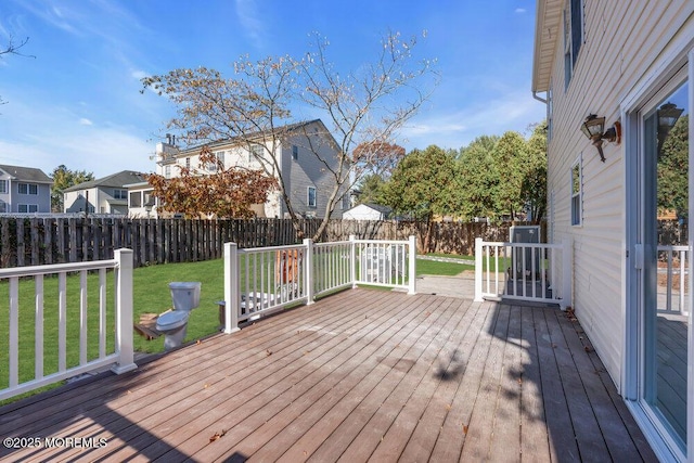 deck with a fenced backyard and a lawn