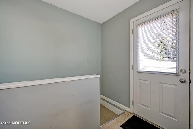 entryway with light tile patterned floors and baseboards