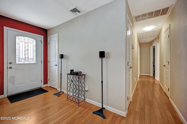 entryway with light wood-type flooring, visible vents, and baseboards