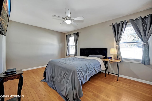 bedroom featuring light wood-type flooring, ceiling fan, and baseboards