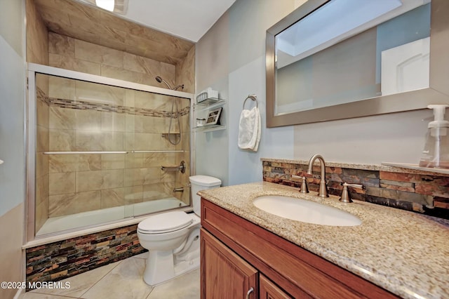 bathroom with tiled shower / bath combo, a skylight, vanity, and toilet