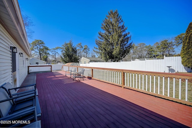 wooden deck featuring a fenced backyard