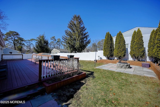 view of yard with an outdoor fire pit, a fenced backyard, a patio, and a wooden deck