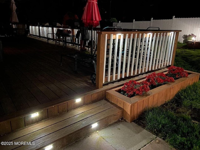 deck at night with fence