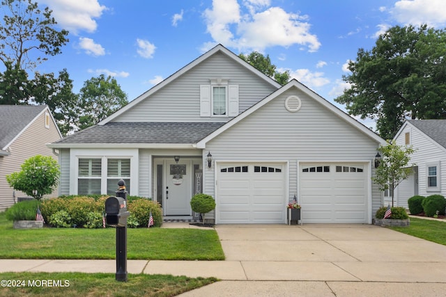 view of front of property with a garage, concrete driveway, roof with shingles, and a front lawn