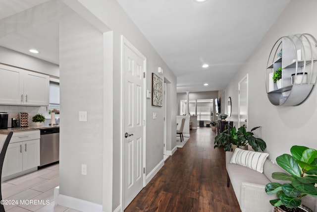 corridor with recessed lighting, light wood-style flooring, and baseboards