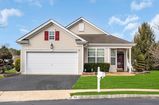 traditional-style house with a garage, a front yard, driveway, and a shingled roof