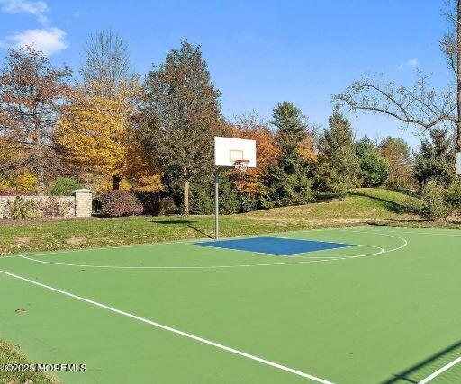 view of basketball court featuring community basketball court and a lawn