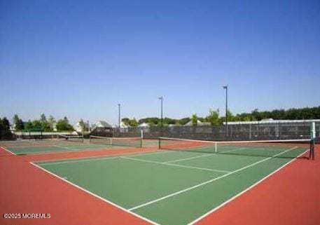 view of sport court with community basketball court and fence