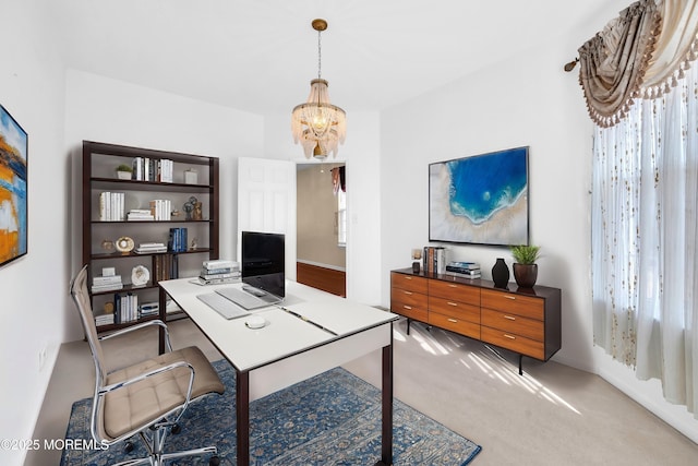 office area featuring a chandelier and carpet flooring