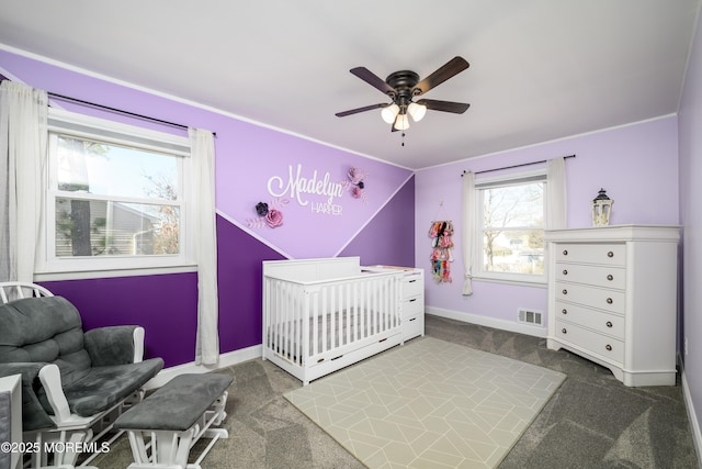 bedroom featuring visible vents, carpet floors, baseboards, and a crib