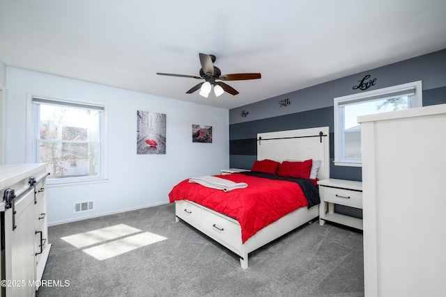 carpeted bedroom with baseboards, visible vents, and ceiling fan