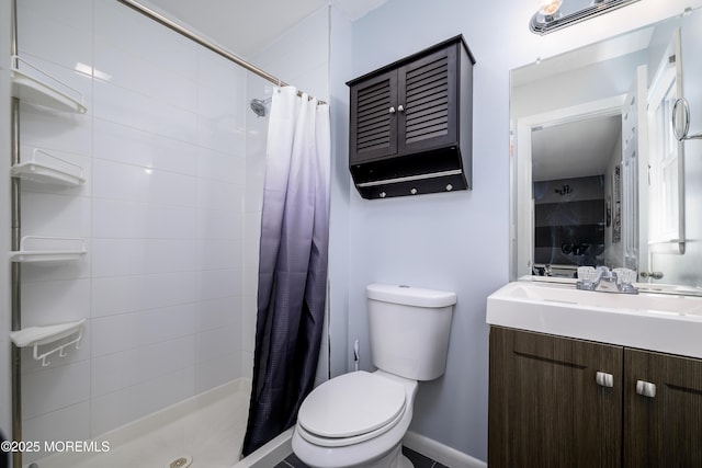 full bathroom with a stall shower, toilet, and vanity