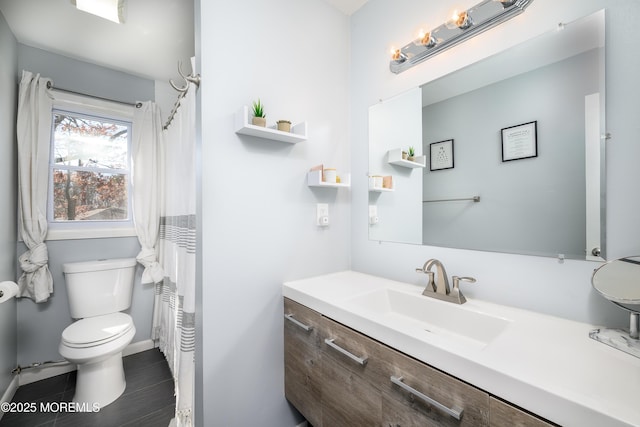 bathroom featuring toilet and vanity