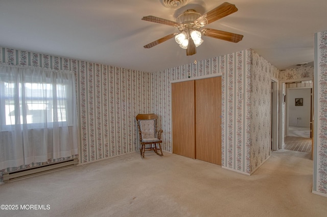 unfurnished room featuring ceiling fan, a baseboard radiator, carpet flooring, and wallpapered walls