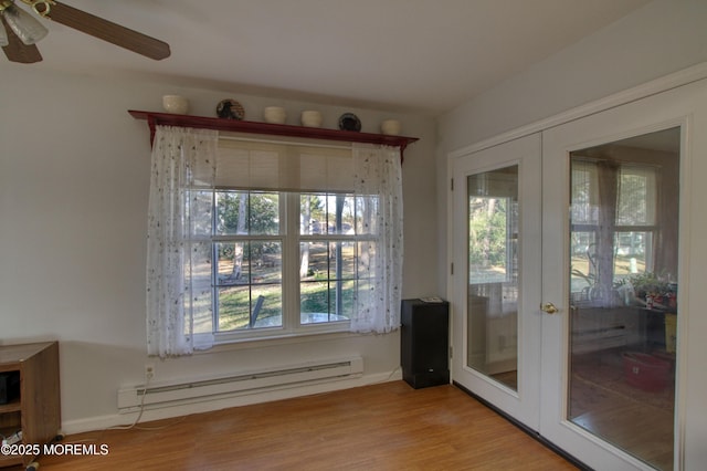 entryway featuring a baseboard radiator, ceiling fan, wood finished floors, and french doors